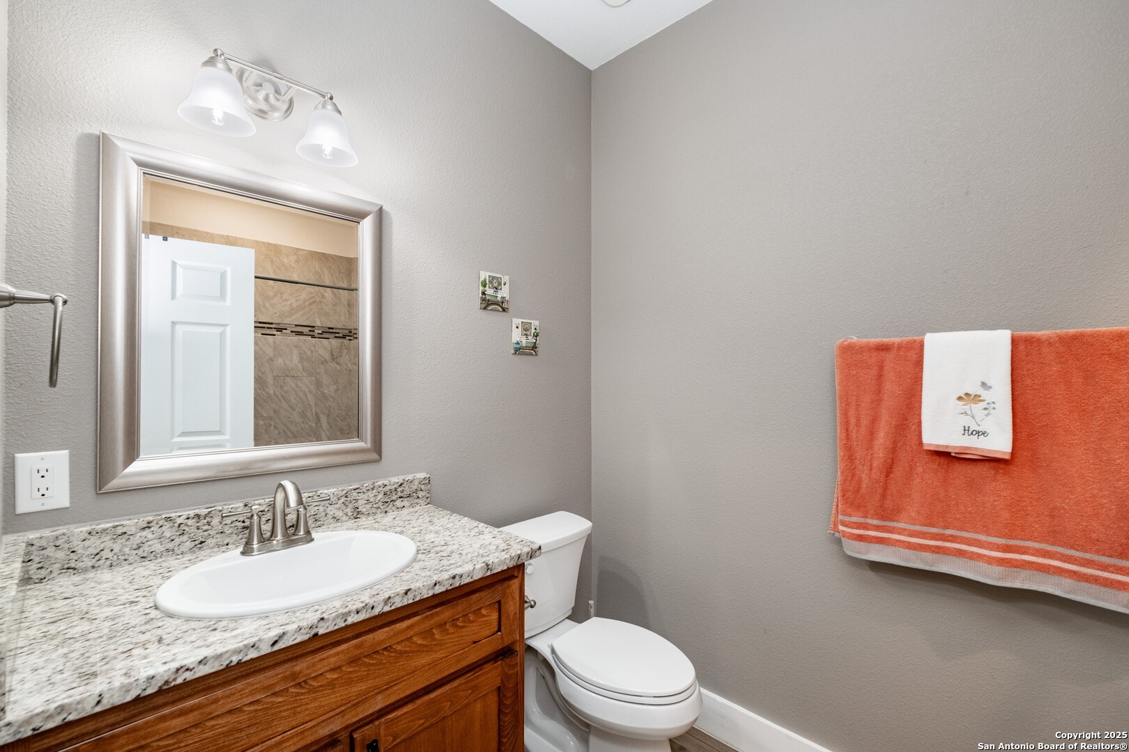 233 N Fork Bandera, TX 78003 - Photo 56 of 71 a bathroom with a granite countertop sink toilet and mirror