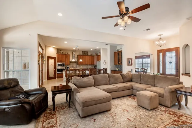 a view of a dining room with furniture and a flat screen tv