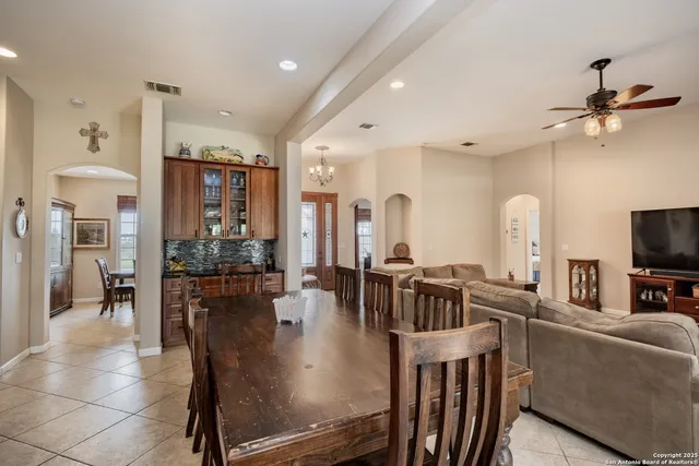 a kitchen with stainless steel appliances kitchen island granite countertop a refrigerator and chairs