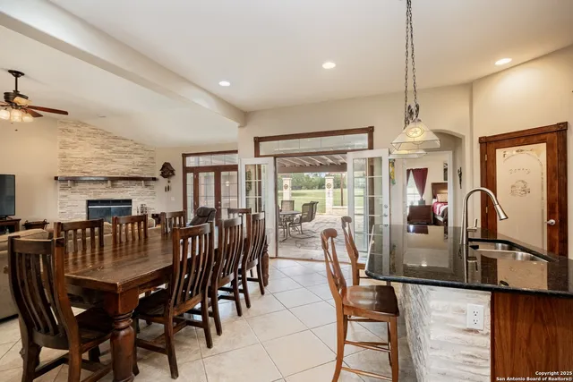 a kitchen with granite countertop a refrigerator and a sink