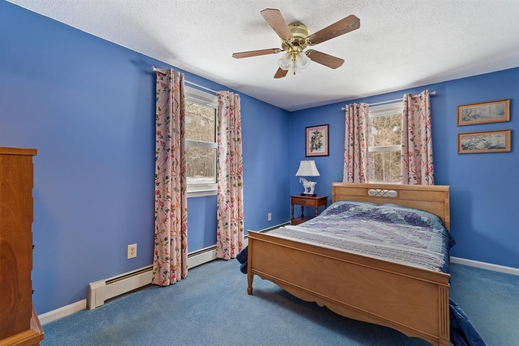 8 Cider Mill Road North Brookfield, MA 01535 - Photo 14 of 30 a bedroom with a bed and a chandelier