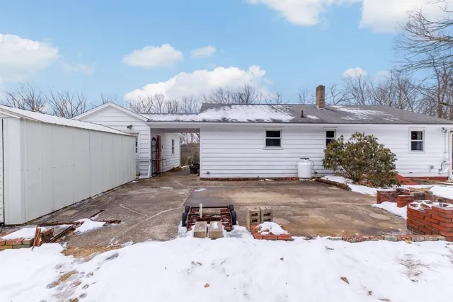 a view of a house with a snow in the background
