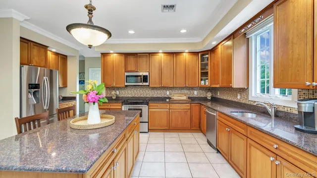 a kitchen with sink refrigerator and cabinets