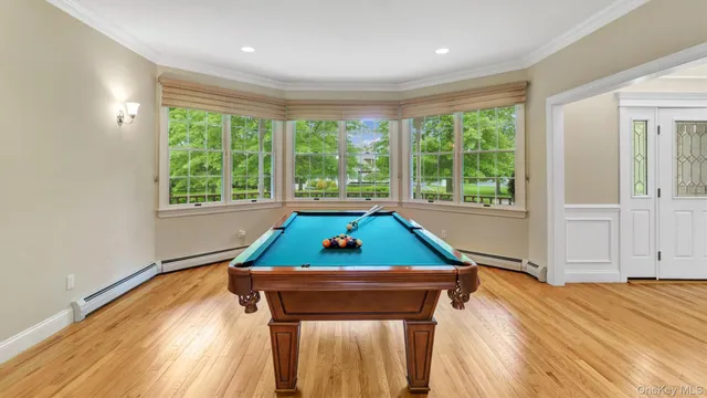 a room with window and pool table