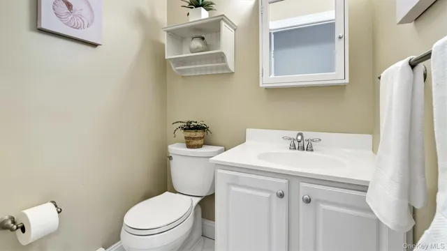 a white toilet sitting next to a bathroom sink