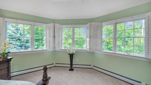 a room with a window and pool table