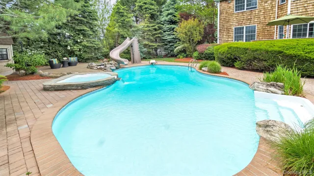 a view of a swimming pool with sitting area
