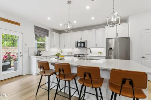 a kitchen with stainless steel appliances kitchen island granite countertop a sink and cabinets