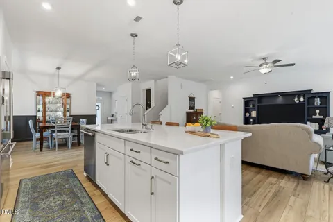a large kitchen with a large window and stainless steel appliances