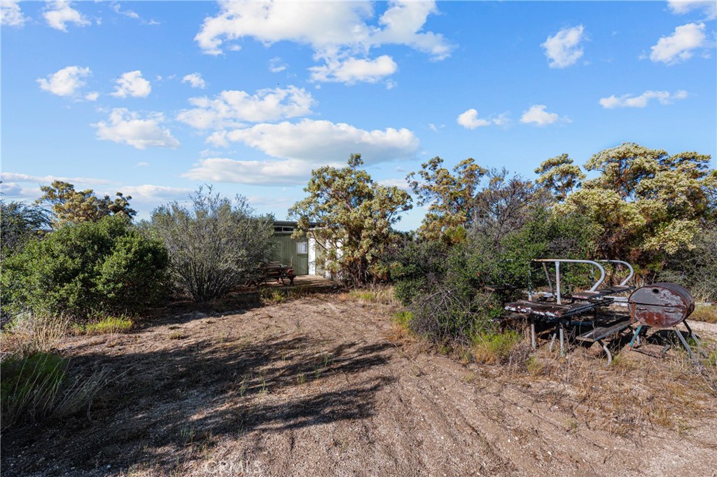 13298 Chihuahua Valley Road Warner Springs, CA 92086 - Photo 18 of 19 a backyard of a house with table and chairs