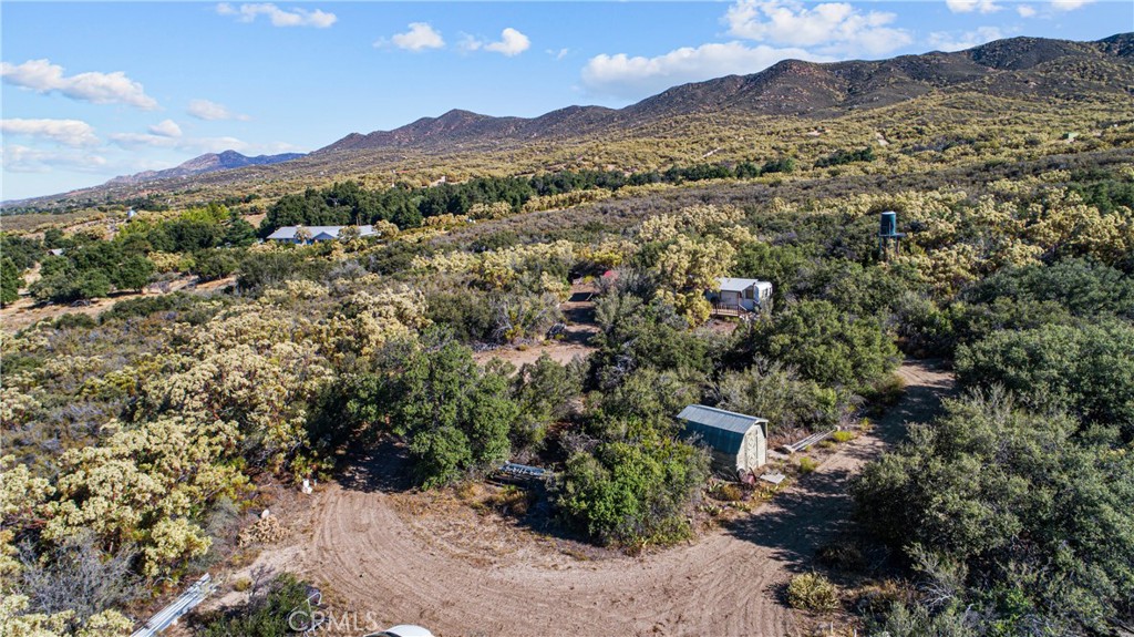 13298 Chihuahua Valley Road Warner Springs, CA 92086 - Photo 5 of 19 a view of a lush green hillside and a houses