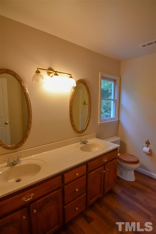 540 North Ridge Circle Roxboro, NC 27574 - Photo 14 of 21 a bathroom with a granite countertop toilet sink and mirror