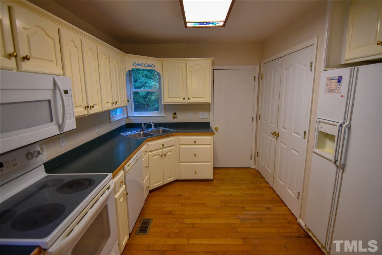 540 North Ridge Circle Roxboro, NC 27574 - Photo 6 of 21 a kitchen with a refrigerator stove and cabinets