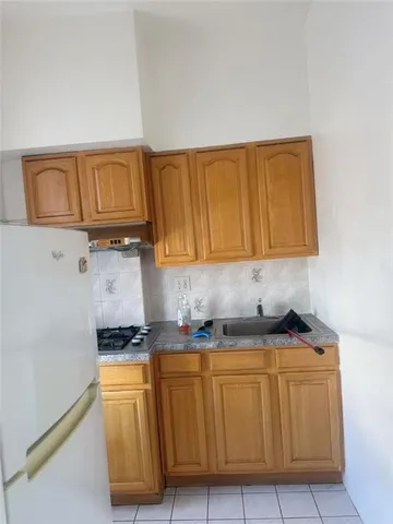 a room with wooden cabinets and a stove top oven