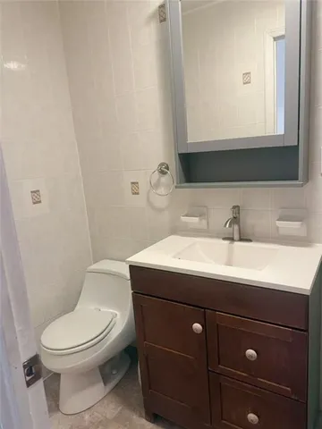 a bathroom with a sink a toilet and mirror