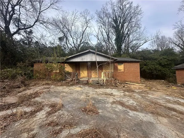 a view of a house with a yard and tree