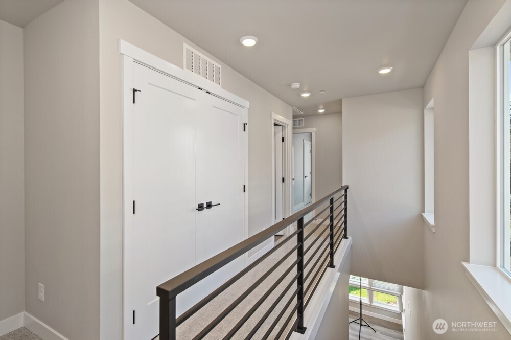6609 South 128th Street Seattle, WA 98178 - Photo 20 of 28 a view of a hallway with wooden floor and staircase