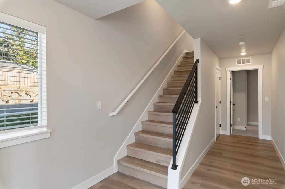 6609 South 128th Street Seattle, WA 98178 - Photo 2 of 28 a view of a hallway with wooden floor and entryway