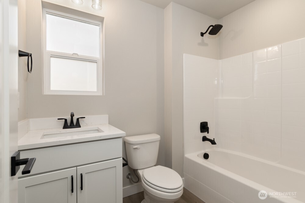 6609 South 128th Street Seattle, WA 98178 - Photo 4 of 28 a bathroom with a sink toilet and shower