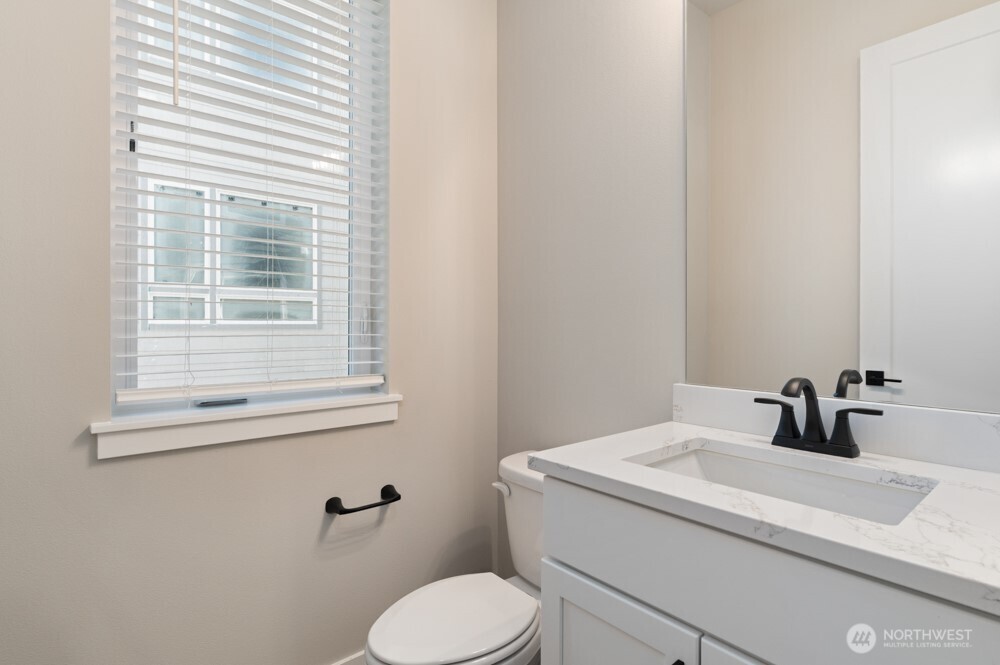 6609 South 128th Street Seattle, WA 98178 - Photo 5 of 28 a bathroom with a toilet sink and mirror