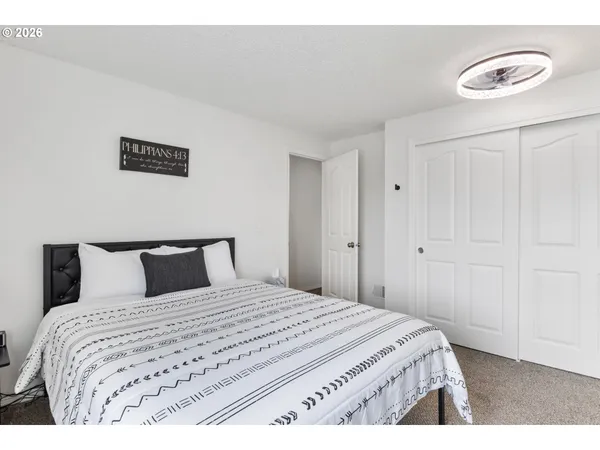 a bedroom with a bed and a lamp