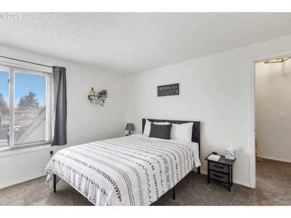 a bedroom with a large bed and a window