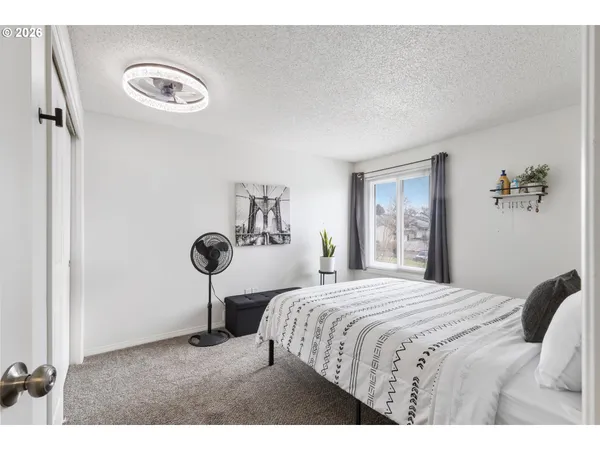 a bedroom with a bed and a table