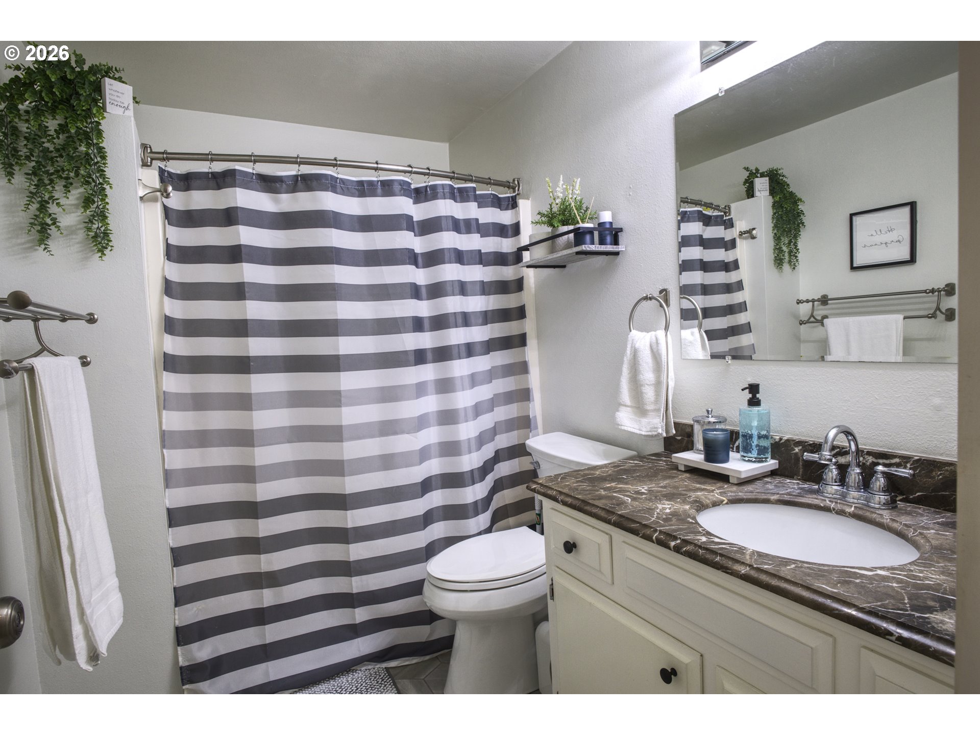 3828 Auburn Road Northeast Salem, OR 97301 - Photo 22 of 34 a bathroom with a granite countertop sink toilet a mirror and shower curtain