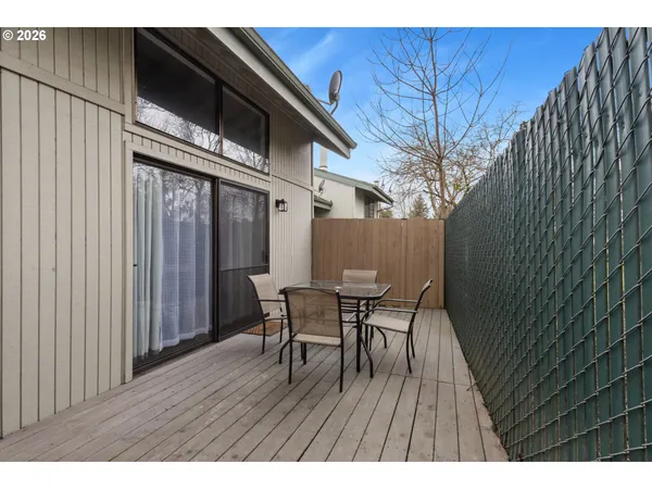 a balcony with table and chairs
