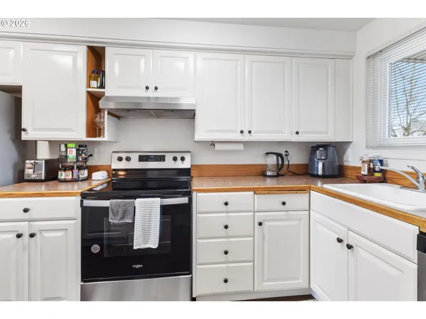 a kitchen with stainless steel appliances granite countertop a sink stove and cabinets