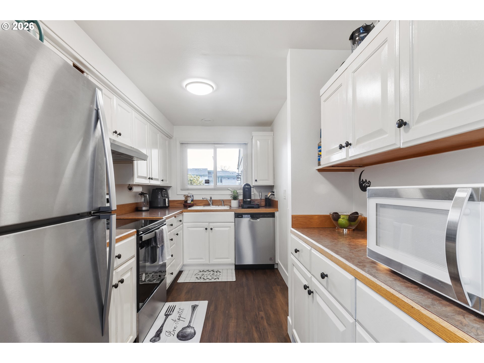 3828 Auburn Road Northeast Salem, OR 97301 - Photo 5 of 34 a kitchen with stainless steel appliances a refrigerator sink and cabinets