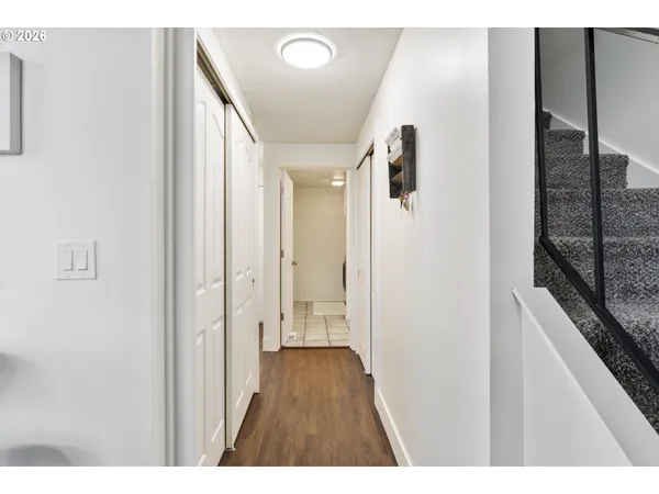 a view of hallway with wooden floor