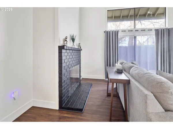 a living room with furniture and a floor to ceiling window