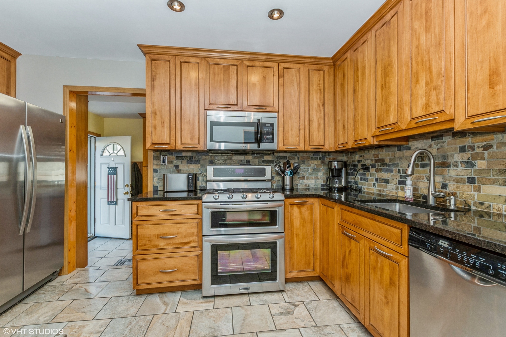 10749 Monitor Avenue Chicago Ridge, IL 60415 - Photo 3 of 11 a kitchen with stainless steel appliances granite countertop a stove sink and cabinets