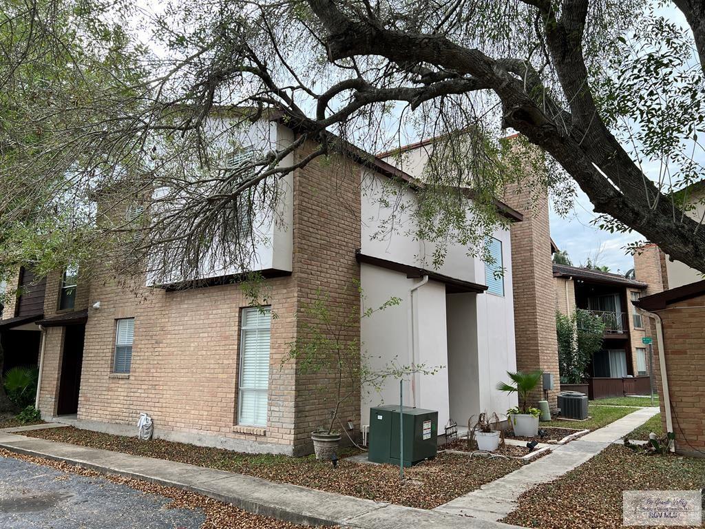 a front view of a house with a tree