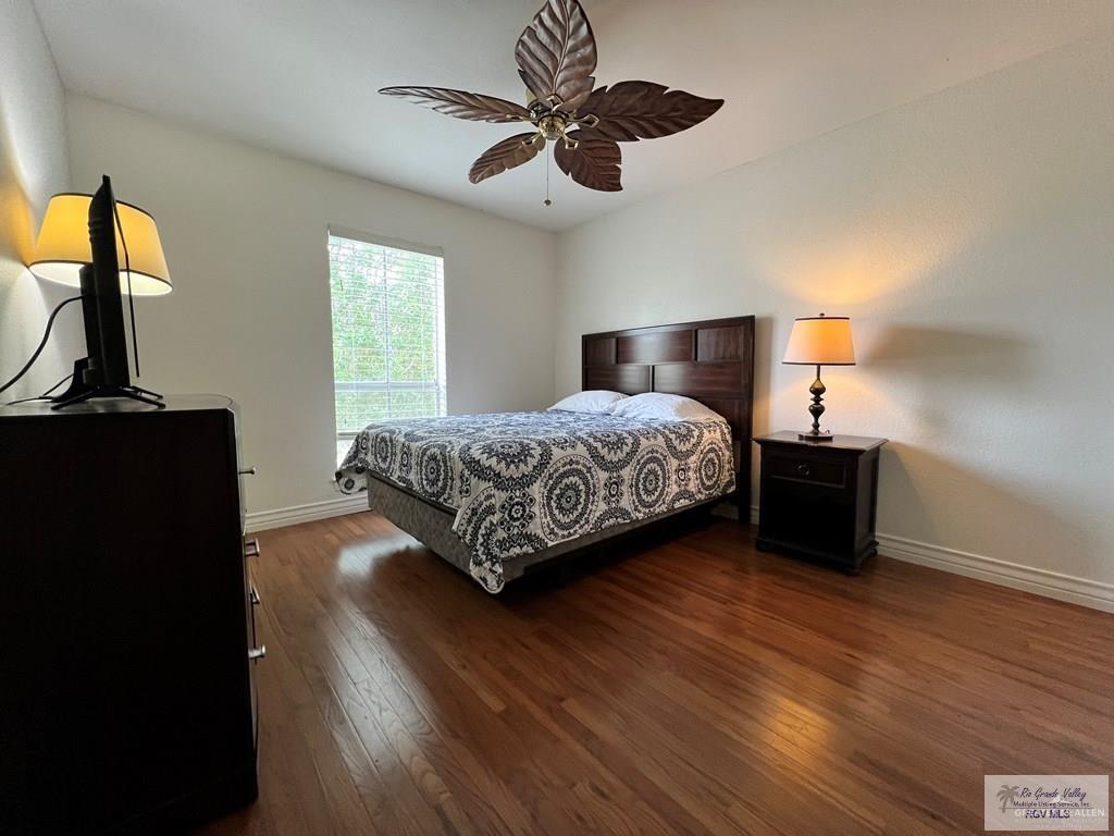 4601 Carmen Avenue Olmito, TX 78575 - Photo 18 of 45 a bedroom with a bed and wooden floor