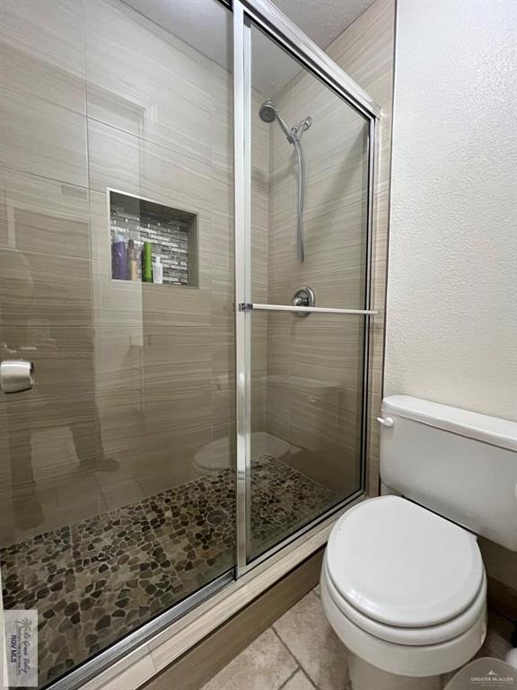4601 Carmen Avenue Olmito, TX 78575 - Photo 19 of 45 a bathroom with a toilet and a shower