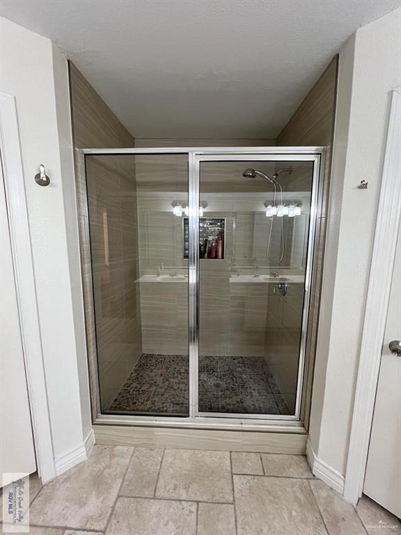 4601 Carmen Avenue Olmito, TX 78575 - Photo 25 of 45 a bathroom with a glass shower door