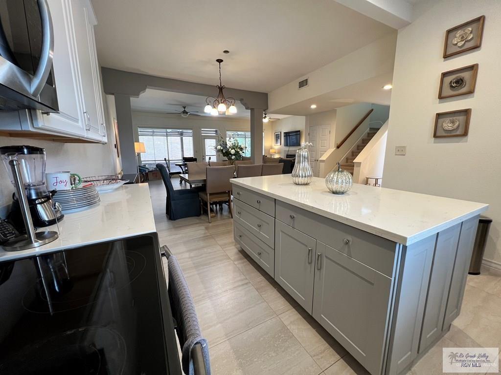 4601 Carmen Avenue Olmito, TX 78575 - Photo 39 of 45 a large kitchen with a sink a counter space dining table and chairs