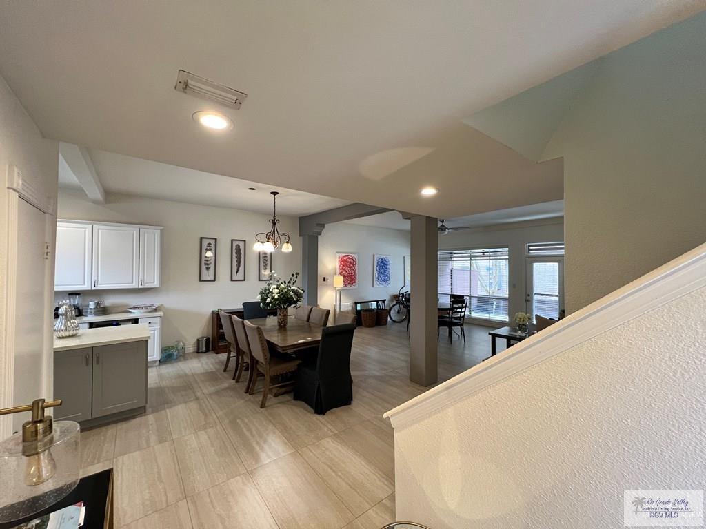 4601 Carmen Avenue Olmito, TX 78575 - Photo 43 of 45 a living room with furniture a fireplace and a dining table with wooden floor