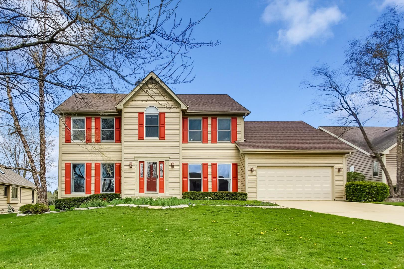 39898 North Harbor Ridge Drive Antioch, IL 60002 - Photo 1 of 27 a front view of a house with a garden and yard