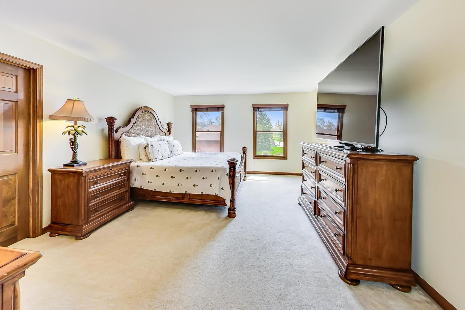 39898 North Harbor Ridge Drive Antioch, IL 60002 - Photo 11 of 27 a bedroom with furniture and a flat screen tv