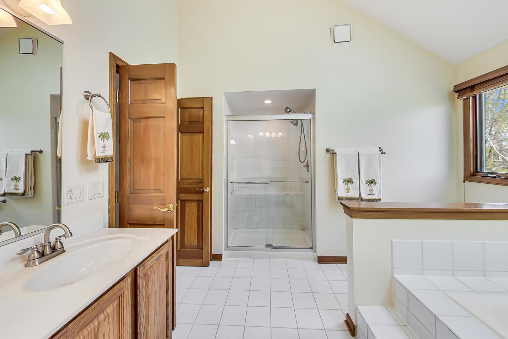 39898 North Harbor Ridge Drive Antioch, IL 60002 - Photo 15 of 27 a bathroom with a sink a mirror and a shower
