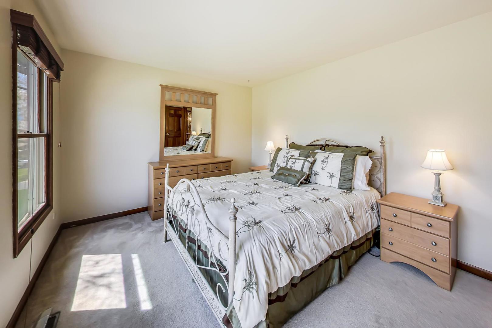 39898 North Harbor Ridge Drive Antioch, IL 60002 - Photo 16 of 27 a bedroom with a bed and a window