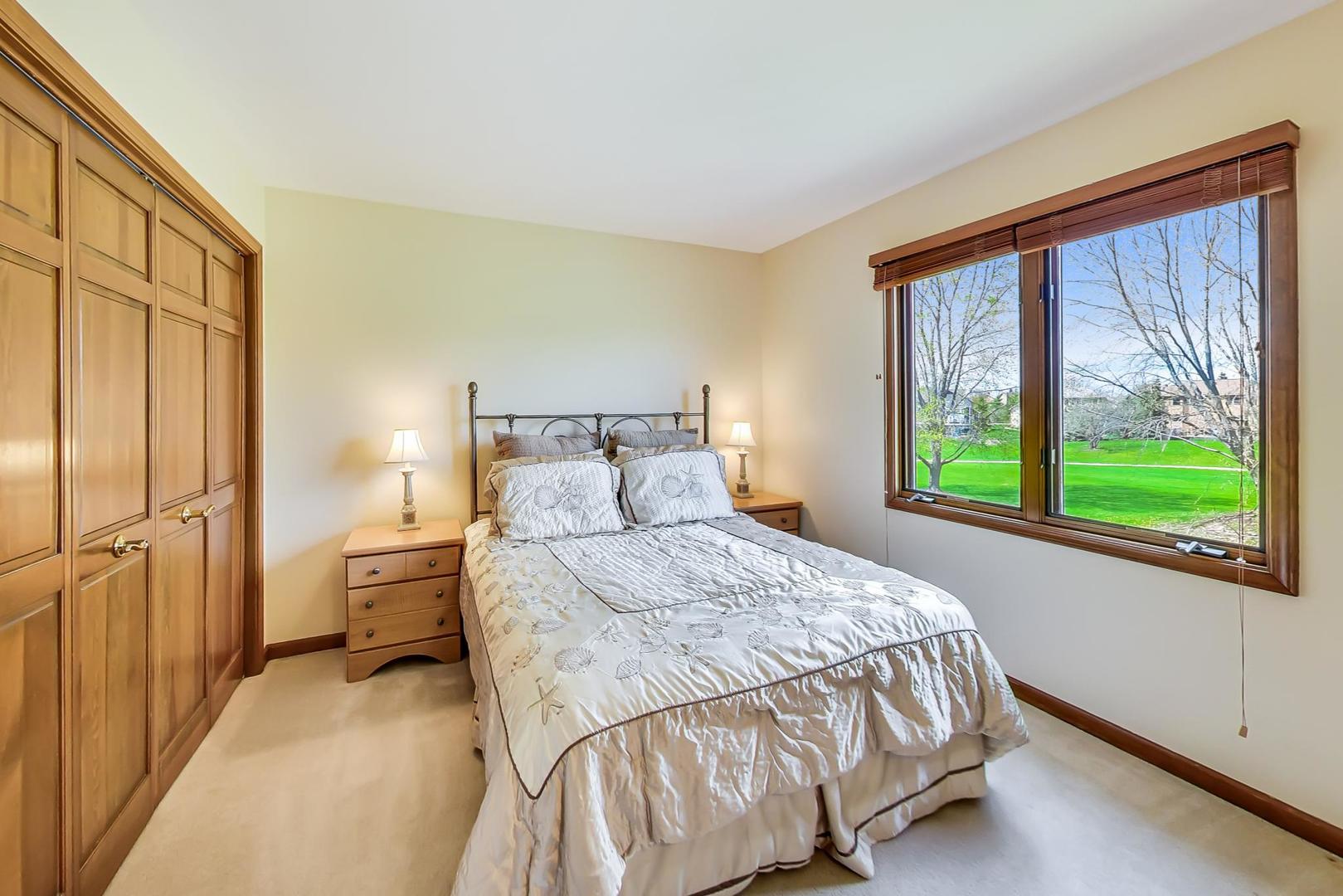39898 North Harbor Ridge Drive Antioch, IL 60002 - Photo 17 of 27 a bedroom with a bed and a large window
