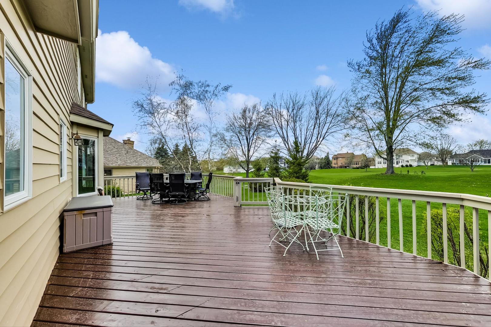 39898 North Harbor Ridge Drive Antioch, IL 60002 - Photo 21 of 27 a view of a patio with dining table and chairs with wooden floor and fence