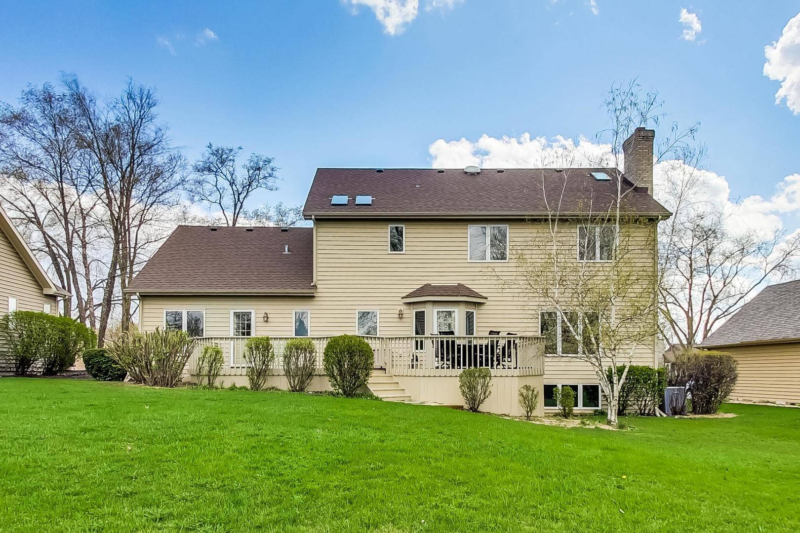39898 North Harbor Ridge Drive Antioch, IL 60002 - Photo 22 of 27 a front view of a house with garden