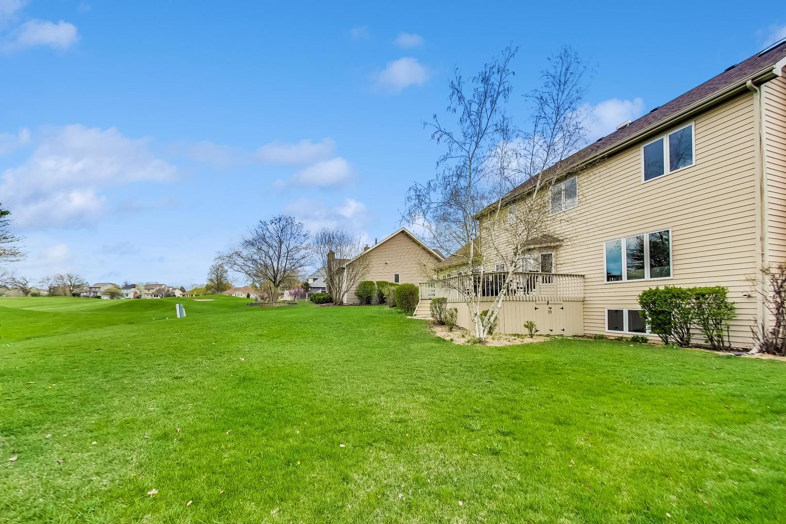 39898 North Harbor Ridge Drive Antioch, IL 60002 - Photo 24 of 27 a view of a house with a big yard and large trees