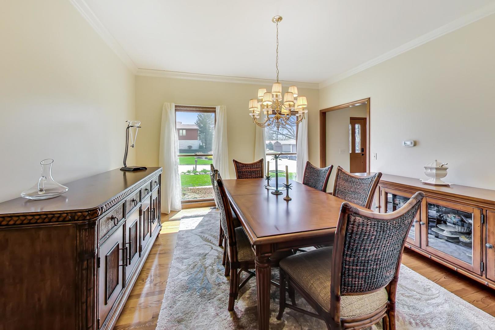 39898 North Harbor Ridge Drive Antioch, IL 60002 - Photo 3 of 27 a view of a dining room with furniture a chandelier and wooden floor
