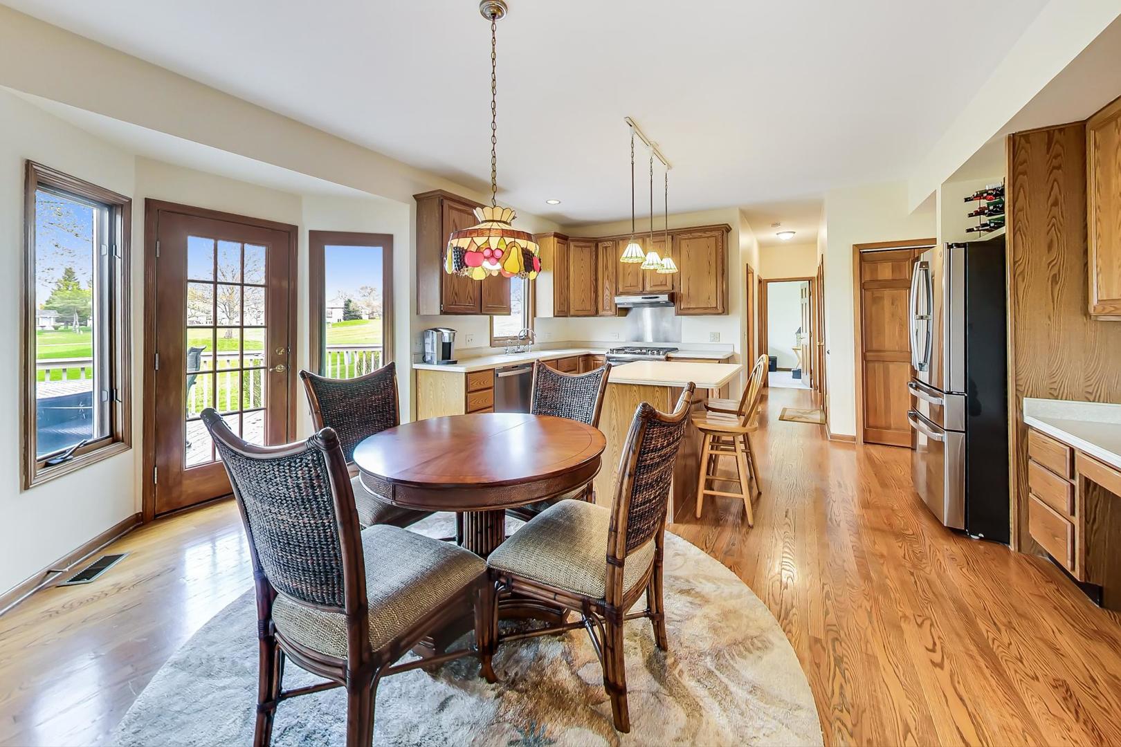 39898 North Harbor Ridge Drive Antioch, IL 60002 - Photo 7 of 27 a view of a dining room with furniture window and wooden floor